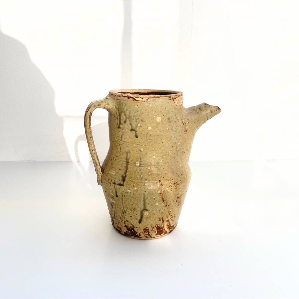 A vintage handmade pottery pitcher signed